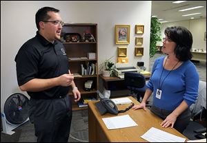 New Toledo city Councilman Shaun Enright meets Paula Howell, an administrative secretary in the council offices at One Government Center. Mr. Enright, 33, was appointed Tuesday to the seat Phil Copeland left.