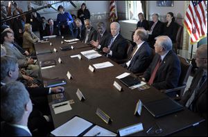President Joe Biden, center, gestures as he speaks during a meeting with Sportsmen and Women and Wildlife Interest Groups and member of his cabinet in the Eisenhower Executive Office Building on the White House complex in Washington. Biden is holding a series of meetings this week as part of the effort he is leading to develop policy proposals in response to the Newtown, Conn., school shooting.