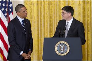 Current White House Chief of Staff Jack Lew looks toward President Barack Obama in the East Room of the White House in Washington, after the president announced that he will nominate Lew as the next treasury secretary.