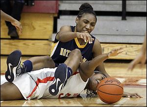 Notre Dame's Kaayla McIntyre lands on Central Catholic's Sydni Harmon as they scramble for a loose ball during the third quarter Thursday night.