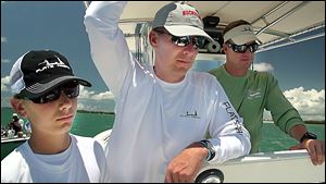 From left, Nate Meyer, Urban Meyer, and Mike Pawlawski fish off the Florida Keys in May. The fishing trip was part of the promise he made to his family before taking the Ohio State job.