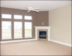 A cozy fireplace is the perfect focal point for this spacious great room.