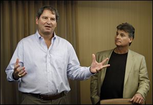 Former Cleveland Browns quarterback Bernie Kosar, left, speaks at a news conference with Dr. Rick Sponaugle, in Middleburg Heights on Thursday.