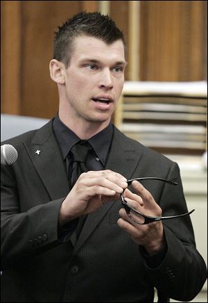 In testimony during the 2010 trial of Ottawa Hills police officer Thomas White, Michael McCloskey showed the glasses he wore while riding his motorcycle. He said their design possibly prevented him from seeing the officer behind him.