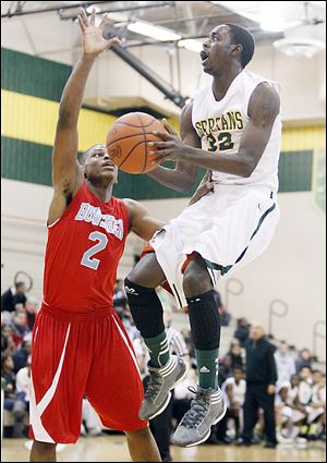 Start's Scott Hicks, who had 32 points, goes to the basket against Bowsher's Aundre Kizer.