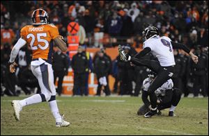 Baltimore Ravens kicker Justin Tucker (9) kicks the game winning field goal as Baltimore Ravens punter Sam Koch (4) holds against the Denver Broncos in overtime of an AFC divisional playoff NFL football game.