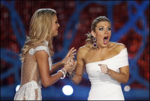 Miss New York, Mallory Hagan, right, reacts with Miss South Carolina Ali Rogers as she is crowned Miss America 2013 on Saturday.