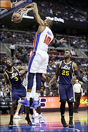 The Pistons' Greg Monroe dunks during the first quarter of Saturday's game against Utah.