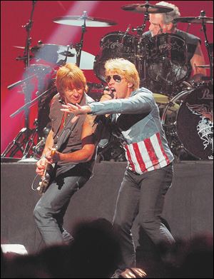 Jon Bon Jovi performs with Richie Sambora, left, at the MGM Grand Arena in Las Vegas.