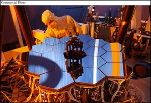 A Ball Aerospace engineer inspects the James Webb Space Telescope testbed telescope.