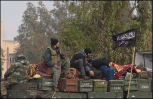 Rebels from al-Qaida affiliated Jabhat al-Nusra sit on a truck full of ammunition, at Taftanaz air base.