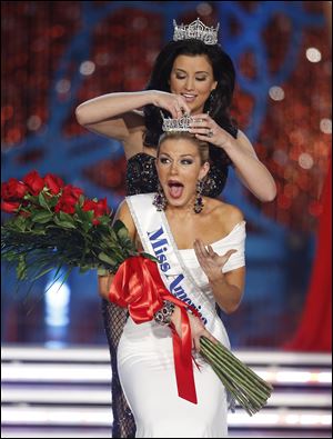 Miss New York Mallory Hagan is crowned Miss America 2013 by Miss America 2012 Laura Kaeppeler on Saturday.