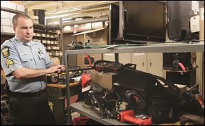 Sgt. Ed Mack of the property room with some of the items that will be picked up by propertyroom.com in the future. 