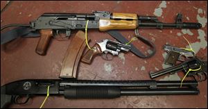 Among weapons in the Toledo police property room are a Romak 2, top, a Romanian-built variant of the AK-47. Its magazine is capable of holding 30 rounds.