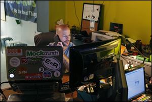 Matthew Marcus works at his desk in the basement of Kansas City Startup Village in Kansas City. Marcus started the Village which houses several startup companies and takes advantage of the high speed internet.