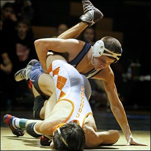 Napoleon's Seth Beard attempts to pin Southview's Tanner Ruiz during the championship match in the 106 pound weight class of this year's Perrysburg Invitational Tournament Saturday at Perrysburg High School.