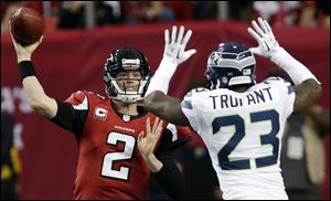 Atlanta Falcons quarterback Matt Ryan (2) throws against Seattle Seahawks cornerback Marcus Trufant (23) during the second half of an NFC divisional playoff NFL football game in Atlanta. 