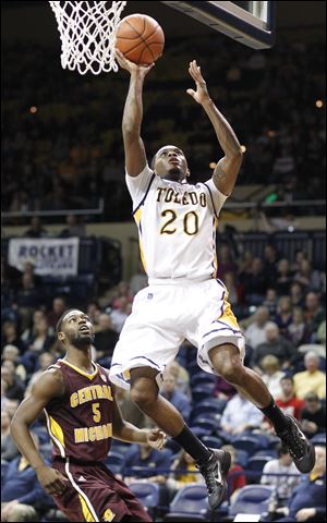 Toledo's Julius Brown goes to the net against Central Michigan'[s Finis Craddock. Brown scored eight of his 21 points in overtime to lead the Rockets.