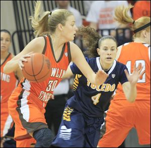 BGSU's Miriam Justinger, left, dribbles past UT's Naama Shafir in the first half Sunday in Bowling Green. Toledo won 48-38.