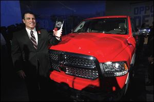 Fred Diaz, President and Chief Executive Officer, Ram Truck Brand, stands with the Ram 1500 after the vehicle was awarded the North American Truck of the Year today.