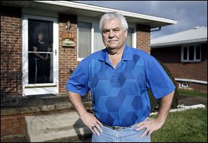 Gary Lindahl stands outside the Point Place home he shares with his longtime girlfriend Sharon Fleck.  Mr. Lindahl, 60, is enrolled in CareNet, an organization that provides medical care to the uninsured.
