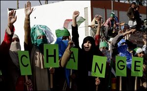 Supporters of Pakistani cleric Tahir-ul-Qadri chant anti-government slogans at a rally en-route to Islamabad, in Jhelum, Pakistan.