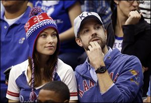 Actress Olivia Wilde, left, and actor Jason Sudeikis watch Kansas play American in an NCAA college basketball game in Lawrence, Kan. Olivia Wilde and Jason Sudeikis are getting married.
