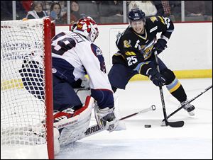 The Walleye's Ben Youds looks to shoot on Kalamazoo goaltender Joel Martin. Youds is one of several players who have been on the move since the end of the NHL lockout. The Red Wings sent him to Rockford of the AHL. Five Walleye players were sent to the AHL.