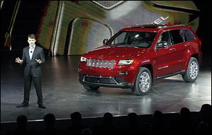 Jeep CEO Mike Manley unveils the 2014 Jeep Grand Cherokee equiped with a diesel engine at the North American International Auto Show in Detroit.