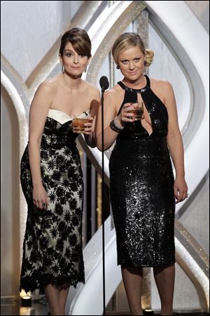 Tina Fey, left, and Amy Poehler got thumbs up on Twitter as hosts of this year's Golden Globes.
