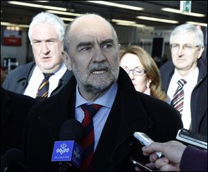 Herman Nackaerts, center, of the International Atomic Energy Agency speaks to the press before his flight to Iran at Vienna's Schwechat airport, Austria, today. The U.N. team is embarking on a new try to restart its probe into suspicions that Iran secretly worked on nuclear arms.