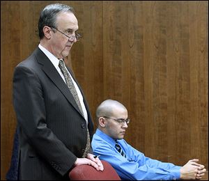 Attorney Jerry Phillips, left, sought acquittal of former dog pound employee Aaron Nova, charged in Toledo Municipal Court with animal cruelty for allegedly throwing a dog against a kennel.