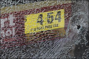 A shot was fired into the entrance door at the Madison Market/Le Pam Pam store in Toledo.