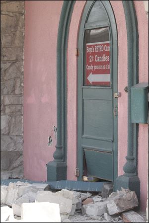 An entrance to Boyd's Retro Candy Store shows damage from car accident debris.