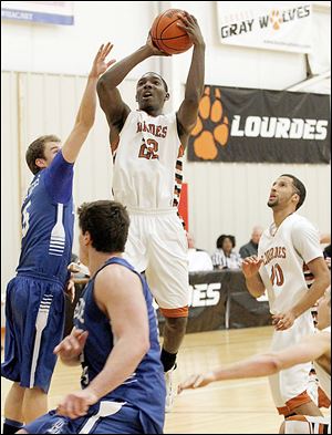 Lourdes' Elvin Butler shoots over Lawrence Tech's Thomas Hoff  during their  game Wednesday at Tam-O-Shanter. Butler had 18 points in the win.