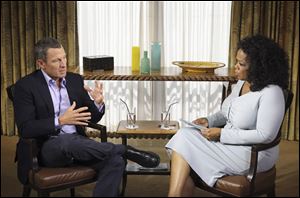 Talk-show host Oprah Winfrey interviewing cyclist Lance Armstrong during taping for the show 