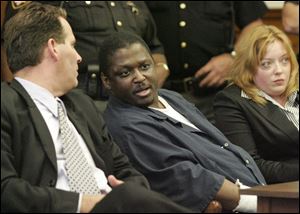 The scheduled 2014 execution of convicted murderer Wayne Powell, shown here flanked by his attorneys during his Lucas County Common Pleas Court trial in 2007, has been canceled. 