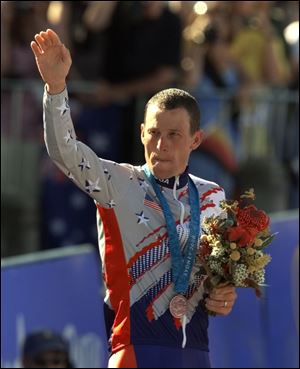 U.S. cyclist Lance Armstrong waves after receiving the bronze medal in the men's individual time trials at the 2000 Summer Olympics cycling road course in Sydney, Australia. 