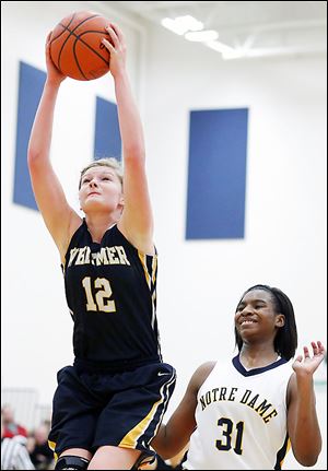 Whitmer's Samantha Meinen pulls down in a rebound in front of Notre Dame's Tierra Floyd. The Eagles stayed perfect in the TRAC with the win.