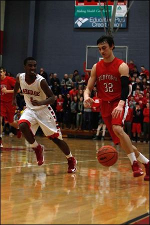 Bedford's Jackson Lamb dribbles down the court against Monroe. Lamb scored a game-high 24 points against southeast Michigan rivals.
