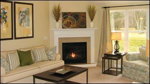 A vaulted ceiling and a gas fireplace with a granite surround make this great room an inviting space. 
