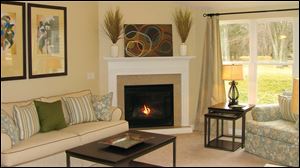 A vaulted ceiling and a gas fireplace with a granite surround make this great room an inviting space. 