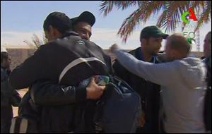 Rescued hostages hug each other  in Ain Amenas, Algeria, in this image taken from television on Friday.