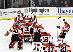 Bowling Green players mob goalie Andrew Hammond after the Falcons defeated No. 10 Western Michigan 3-2 on Friday. The Falcons are on a six-game unbeaten streak.