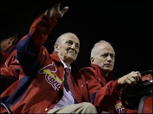 Hall of Famer Stan Musial wave as he drives around Busch Stadium in October before Game 4 of baseball's National League championship series between the San Francisco Giants and the St. Louis Cardinals.