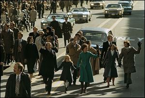 President Jimmy Carter walks with first lady Rosalynn, with daughter Amy between them during the inauguration parade down Pennsylvania Avenue in Washington. 