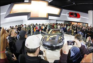The 2014 Corvette Stingray proved to be the main attraction during the first day of the auto show. A crowd encircled it, hoisting smart phones to snap photos and waiting to get a closer look at the impressive sports car.