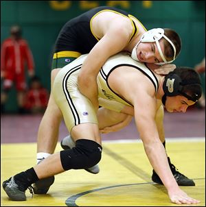 Matt Stencel of Clay controls Kadin Llewellyn of Perrysburg in the 182-pound championship match at the Michael Casey Memorial Classic wrestling tournament at Clay. Stencil pinned the top-seeded Llewellyn.