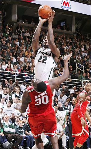 Michigan State's Branden Dawson (22) goes over Ohio State's Evan Ravenel (30) for a shot during Saturday's game in East Lansing, Mich. The Buckeyes fell to 13-4 overall, 3-2 in the Big Ten.