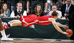 Ohio State's Aaron Craft dives for a loose ball during the first half against Michigan State.